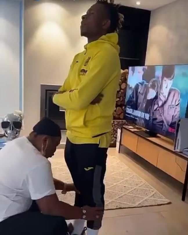 AFCON: Chukwueze's Mum Releases Blessings Ahead Of Him, Prays While Holding His His Legs