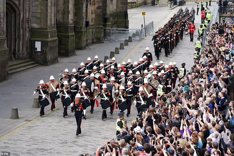 The Royal Marines march down the Royal Mile during an Accession Proclamation Ceremony at Mercat Cross
