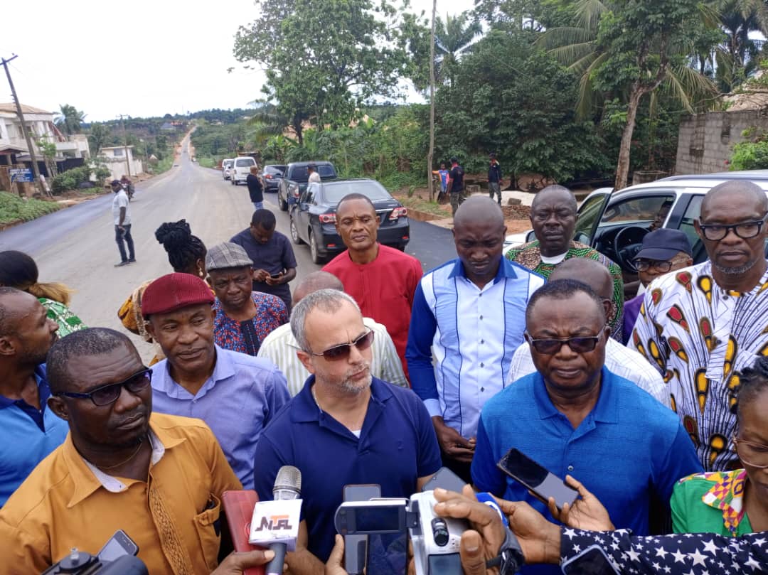 Rep Sam Onuigbo at the Okwe Oboro section of the reconstructed Umuahia-Ikwuano-Ikot Ekpene Federal Road asking the Project Engineer, Hisham Yassin, to explain the extent of work covered and their challenges, if any, during the inspection of on-going work along the road on April 13, 2023.