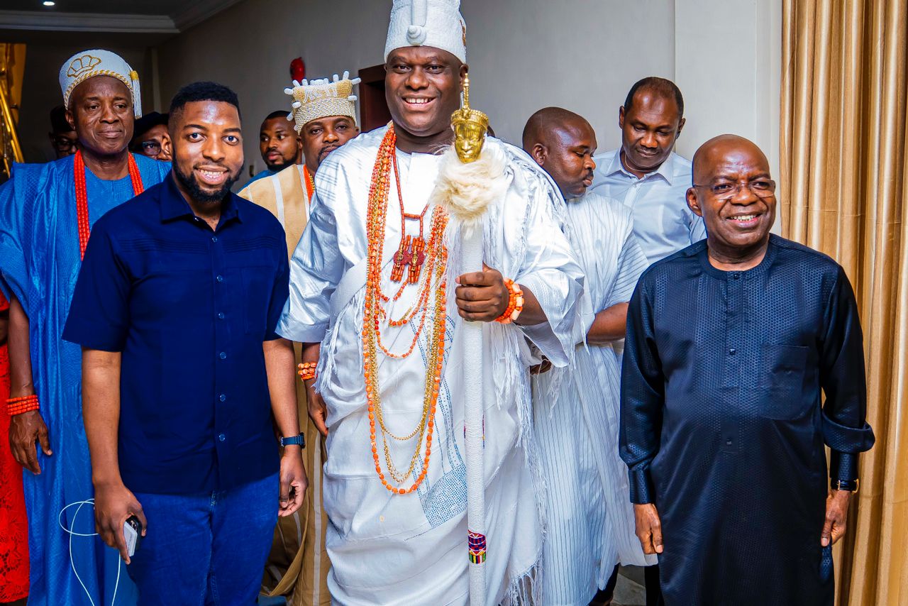 The Ooni flanked by Governor Otti and his son, Alex Jnr