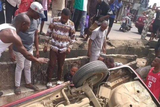 Woman Cheats Death As Car Somersaults Into Erosion Pit In Aba (Photos) Woman Cheats Death As Car Somersaults Into Erosion Pit In Aba (Photos